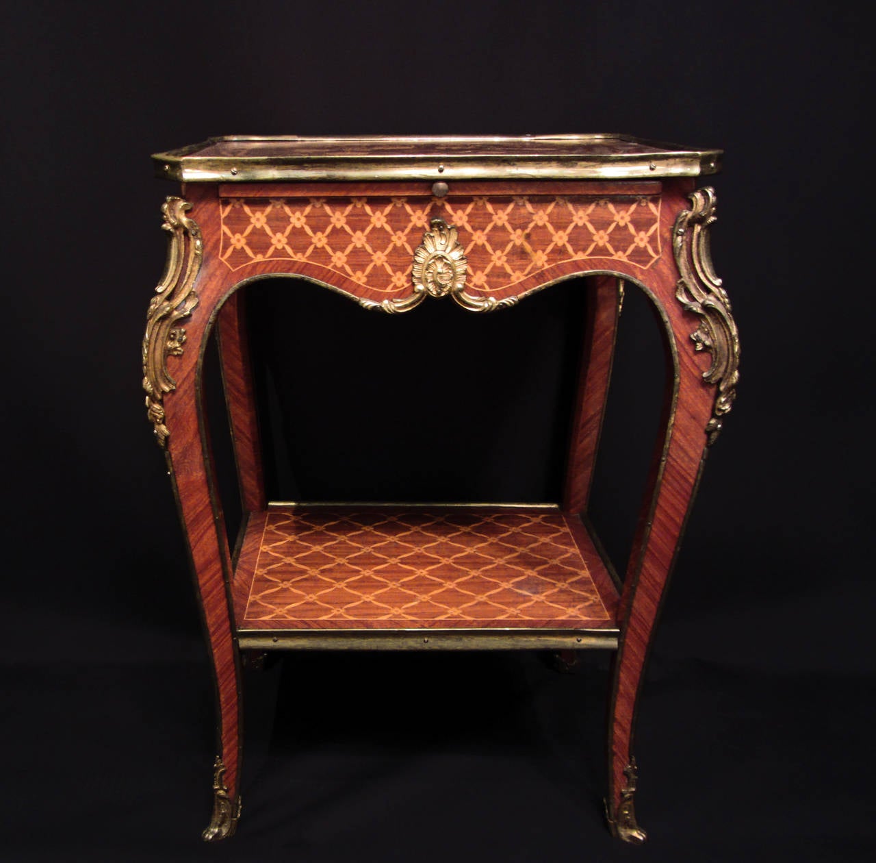 A pair of French salon tables with marquetry inlay tops and shelf, decorative ormolu mounts and feet on cabriole legs and a sliding top draw. Stamped with J Sargues. 

French, late 19th century. 

Measures: Width 48 cm, height 72 cm, depth 38 cm.
