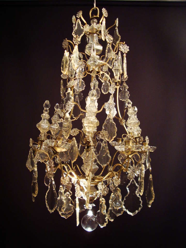 An exquisite Louis XVI period bronze and crystal chandelier, the birdcage shaped bronze frame bearing stamped numbers, typical of the period, allowing the chandelier to be dismantled for travel with its owners in the 18th century, profusely hung