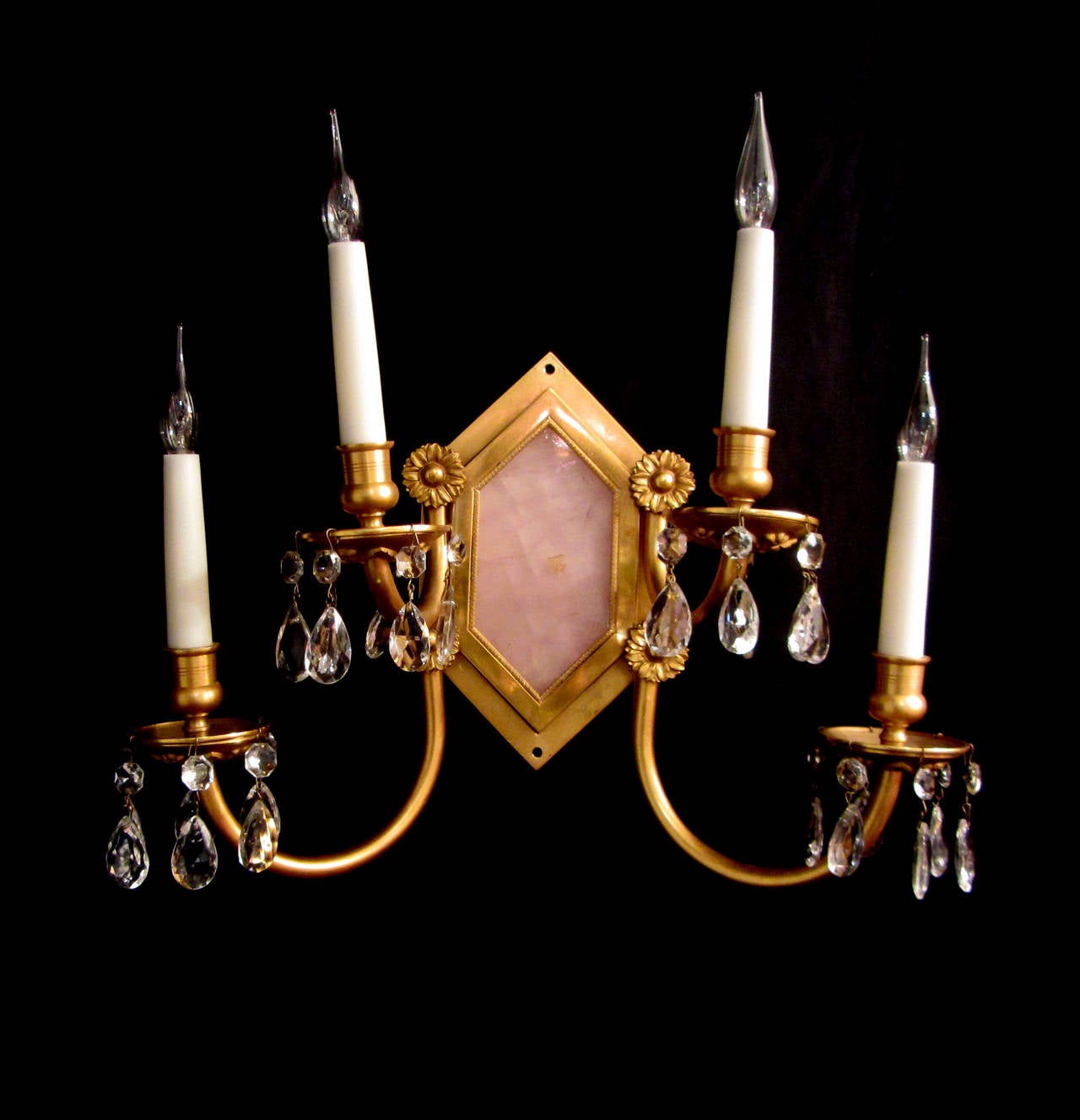 A most unusual pair of solid pink quartz and gilt brass four armed wall lights, with rosette and crystal drop decoration.