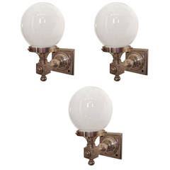 Vintage A set of three glass globe silvered bronze wall lights