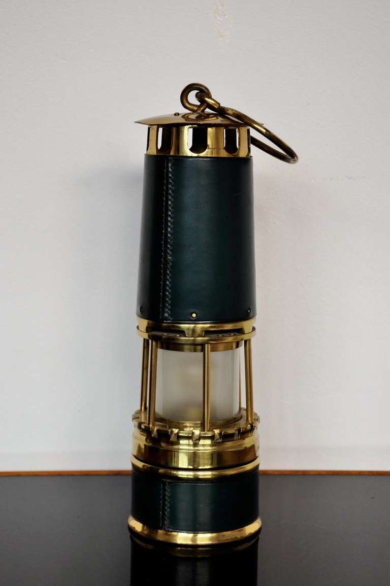 Arras mining lantern for Hermes (unsigned). The lamp is in excellent period condition.
Manufactured of yellow bronze, forest green Hermes leather and frosted Baccarat crystal insert.