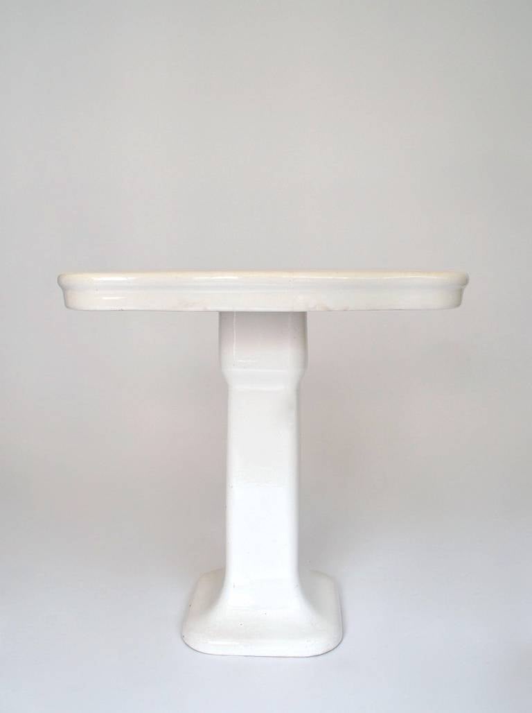 Circa 1930 porcelain bathroom console. The console is probably of European design and production. In very good period condition, no chips showing  normal signs of use to the surface. The porcelain exhibits crackling typical of aged porcelain.
