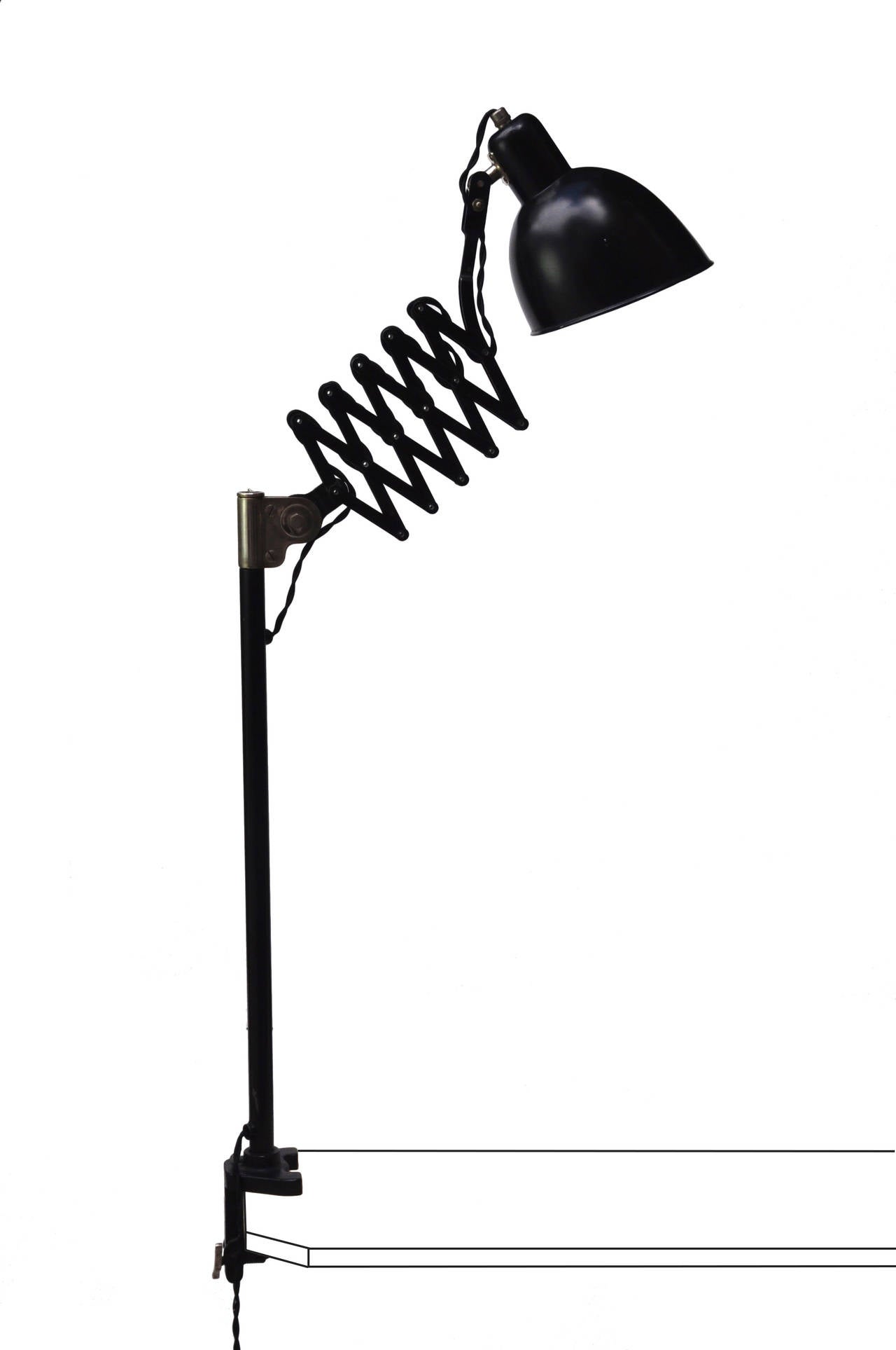 The adjustable surface clamp lamp with a handy accordion system and sturdy vice mechanism is a Belmag hybrid of the standard workshop and wall accordion lamp. 
The accordion mechanism will rotate 360 degrees the system can also be positioned