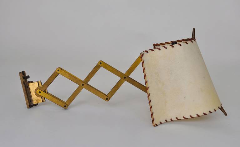 A good pair of nicely aged appliques by the Swiss designer and manufacturer Alfred Muller for his company AMBA.
The appliques are nicely preserved the original silk shade covering has been updated with original parchment and sown in leather. When