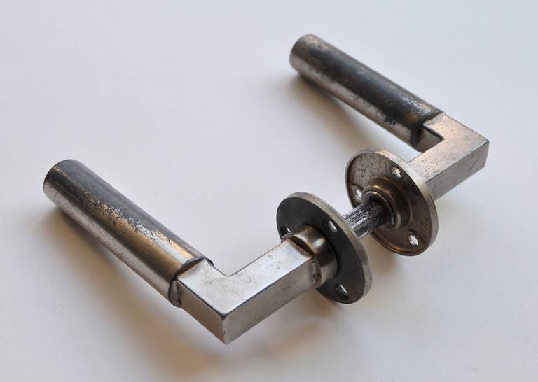 Modernist door handles by Walter Gropius and Adolf Meyer. First designed in 1922. There are 12 sets in total each exhibiting its distinctive time worn characteristics. Sold either individually or in sets.