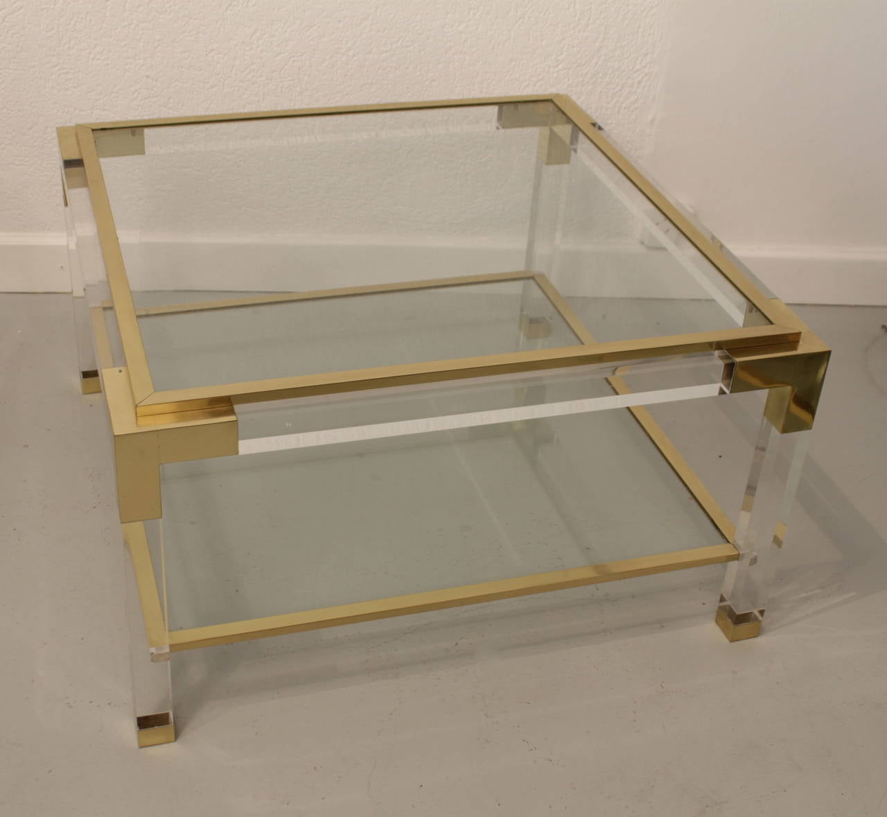 Lucite, brass and glass coffee table, Italy, circa 1970
The top glass is movable and edges are fitted with slip on brass trim. Very good quality.