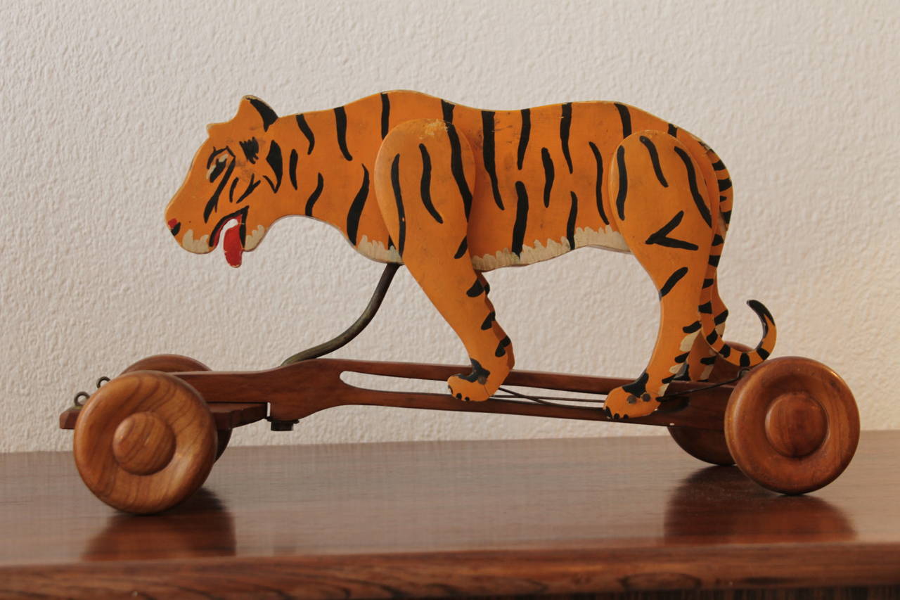 Rare wooden pull toy. 
Hand painted. 
Articulated legs are moving while the toy is rolling