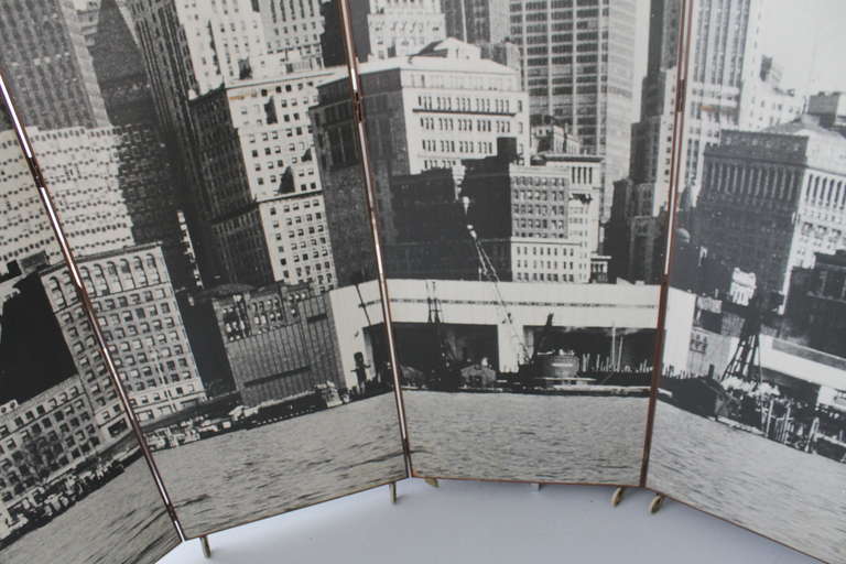 Double face vintage Manhattan Skyline folding screen.
5 wood panels covered with photos of Manhattan in the 1950's.
Walnut frame and brass hinges.
Mounted on wheels (two are missing, one is damaged but can easily be replaced).
Scratches and