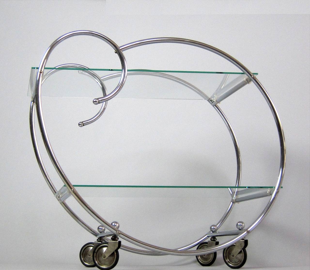 Clearly and concisely designed chrome trolley with two glass shelves, which has been replaced, France, 1930s.