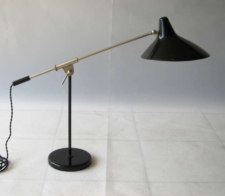 Elegant adjustable table light, very harmonic design, with beautiful and pure details.
New glossy deep black lacquer, nickled arm and fixation, rewired