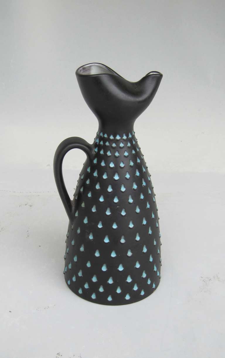 Handmade ceramic jug with spout who keeps back fruit pieces and ice cubes, Luzern Ceramics, 1960s, black body with light blue 