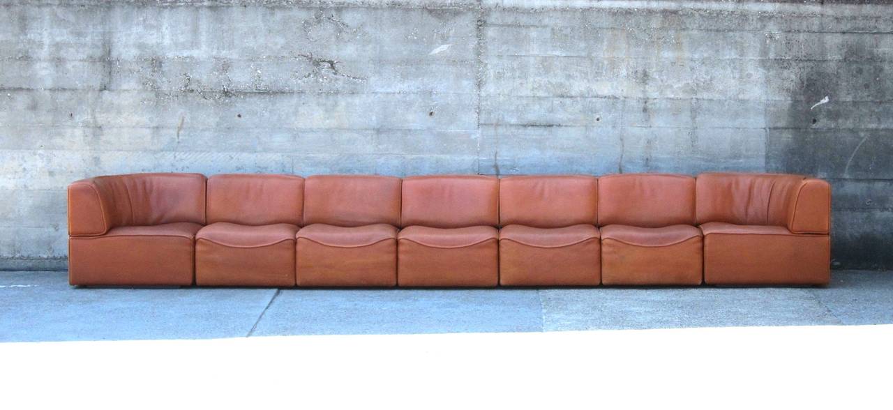De Sede Switzerland produced this Sofa in the 1960's in a thick premium Leather Quality. Very comfortable 7-Elements Sofa with nice Patina.
No holes, no rips, partially Fading on the Back.
Total Length 460cm/15 feet.
The Elements are connected