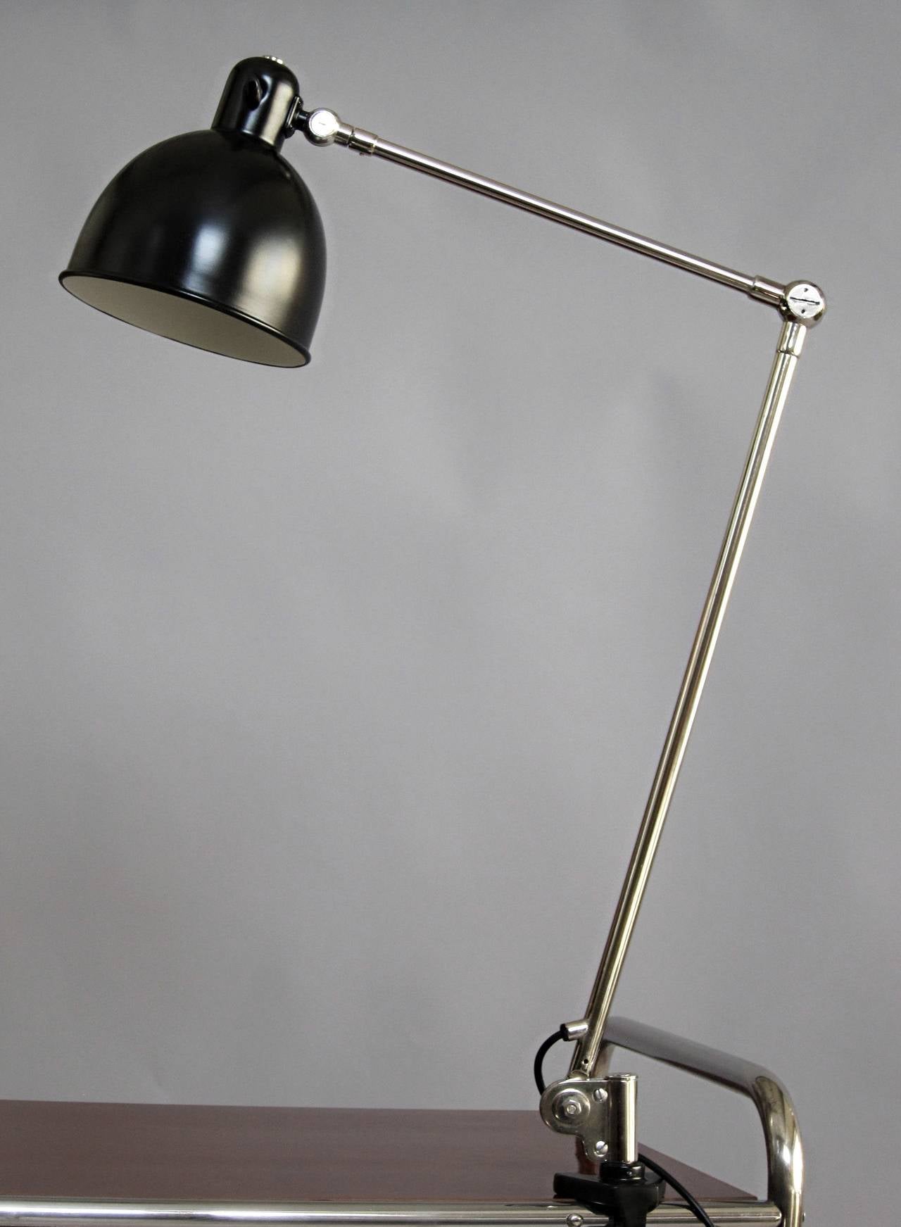 Desk lamp by Belmag, Zurich, Switzerland, 1940s, nickel-plated leverage and black lacquered aluminum shade, restored and rewired.
The lamp can be rotated and moved in many different positions.