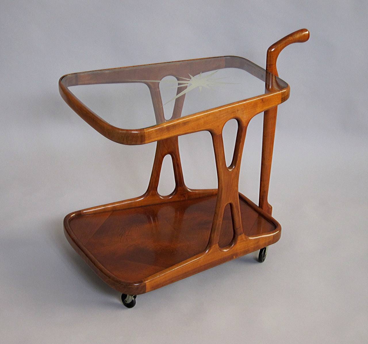 Beautiful shaped wooden Bar Cart, smooth running one Hand Operation,
original Glass top with Star Pattern, Italy 1950s, attributed to Cesare Lacca