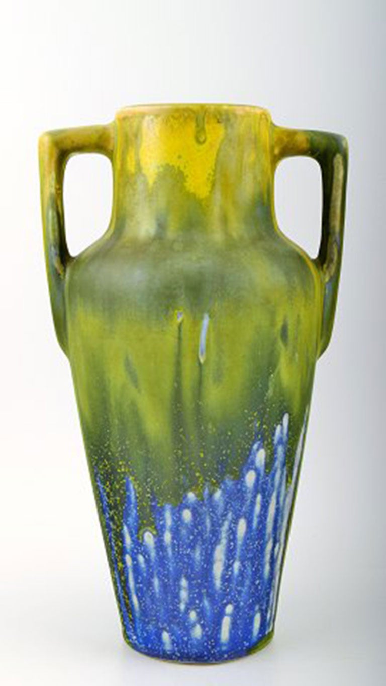 Gilbert Metenier, French ceramist. Art Deco vase with flaming yellow, blue and green glaze. 1920-30s. Signed.
Height 25.5 cm. In perfect condition.
Gilbert Metenier was born in 1876 and took over his father's pottery in Gannat in central France