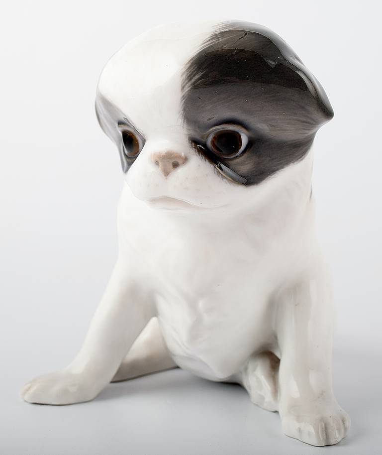 Rare Royal Copenhagen Pekingese puppy. Number 448. Measures: Height 14.5 cm. 17 cm. long. 
Factory first and in excellent condition. Artist Erik Nielsen.