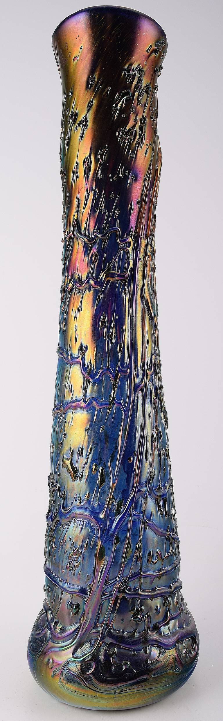 Large Art Nouveau Loetz style art glass vase. Rainbow colors with shades of purple and golden green. Measures: H. 49 cm. In good condition.