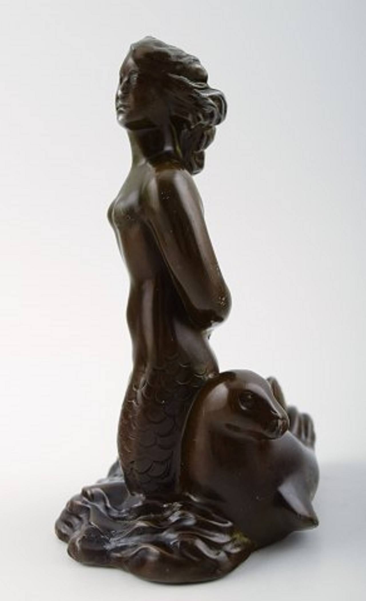 Figure of seated mermaid, designed by Just Andersen.
Denmark, 1940s.
The figure is made in metal and signed 'Just A'.
Number 1930.
Measures: Height 13.5 cm.
In good condition, a little wear.