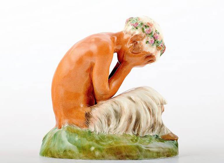 Gerhard Henning for Royal Copenhagen crying faun or pan, number 1188. Overglaze. 
Factory first, perfect condition. 
Juliane Marie stamp, dated 10/24/1946. 
Measures: 11 x 13 cm.