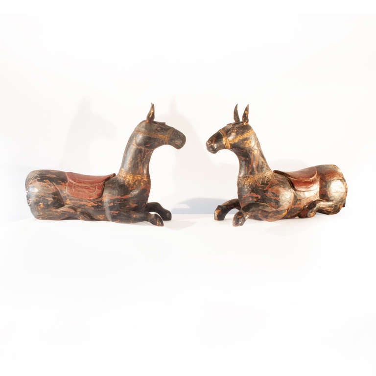 A pair of attractive and unusual painted wood recumbent mules, probably 19th century.  Purchased in Pakistan and used as a decorative object in Blakes Hotel, London for many years.