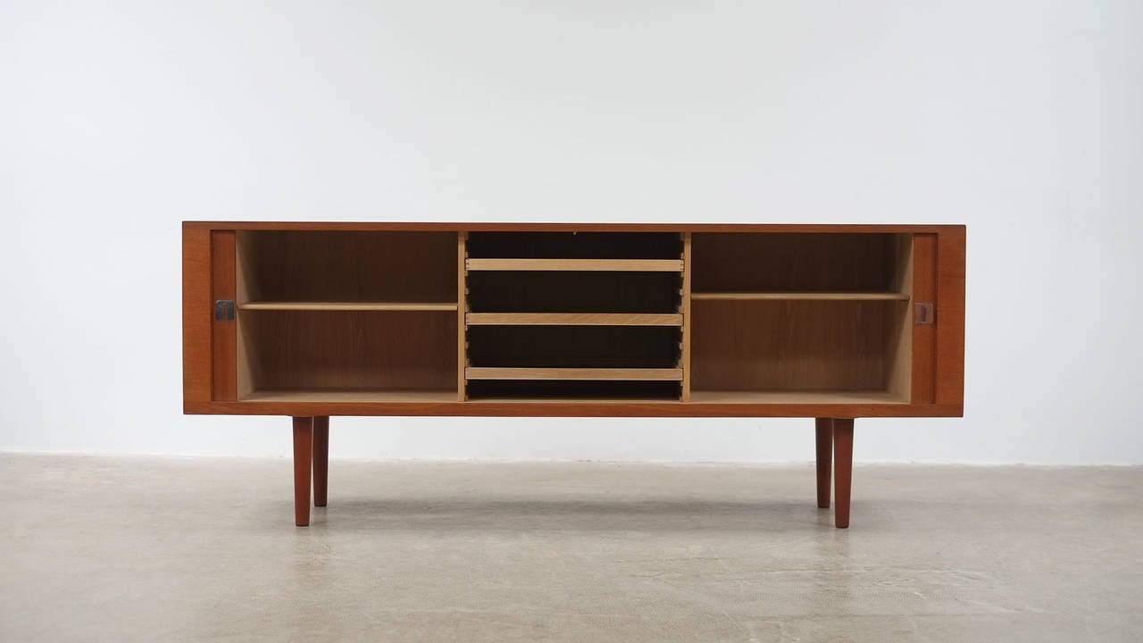 Amazing and rare President sideboard in teak with contrasting oak interior designed by Hans Wegner for RY Mobler, Denmark. Super sought after piece of Wegner design with beautiful proportions and excellent details.  Wonderful piece.