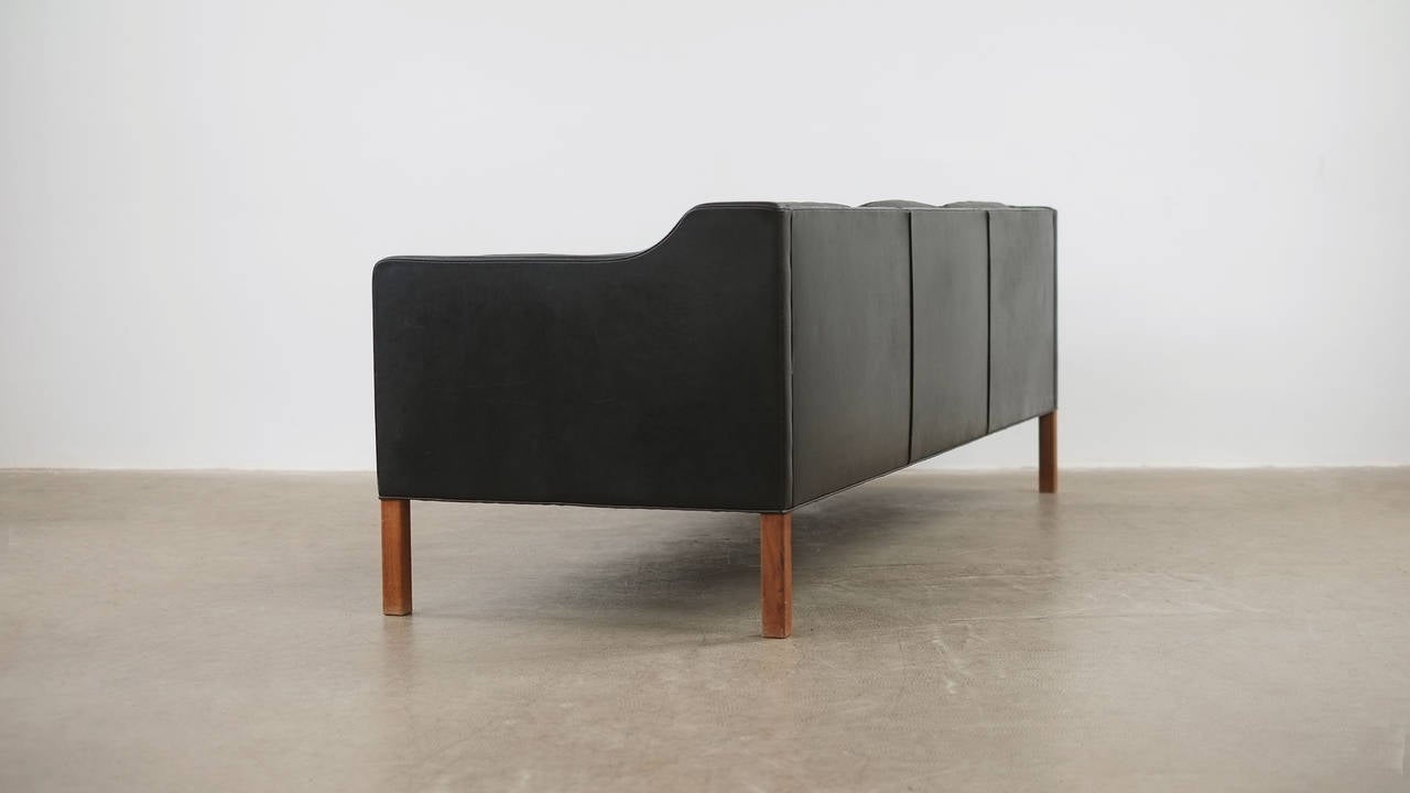 The real thing… Fantastic example of the classic 3 seat sofa designed by Borge Mogensen for Fredericia, Denmark model 2213. Unsurpassed quality and in beautiful patinated black leather with solid teak legs. Wonderful.