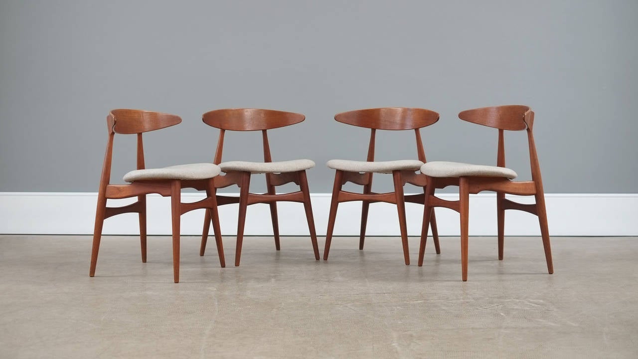 Rare and beautiful set of CH33 chairs in teak designed by Hans Wegner for Carl Hansen, Denmark. Amazing and super sculptural chairs with great exposed joint details. These examples in fantastic original condition with new woolen upholstery seats are
