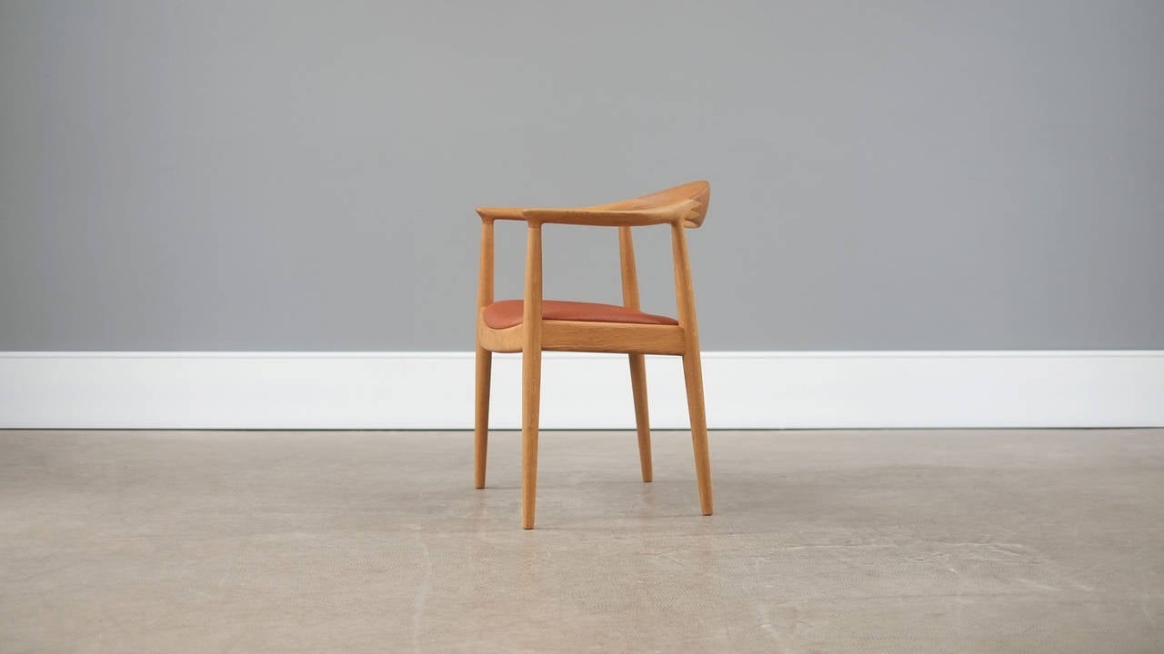 Rare Round Chair in oak designed by Hans Wegner for cabinet maker Johannes Hansen, Denmark. Fabulous quality, details and ultra elegant design. This example with cognac leather seat. The most famous of all Wegner pieces.