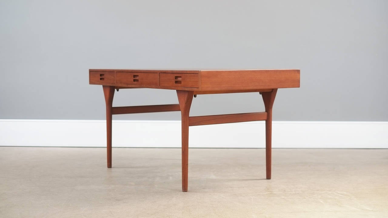 Famous and sought after desk designed in 1958 by Nanna Ditzel for Soren Willadsen, Denmark. Wonderful example in superb teak with ash lined drawers. Super elegant, high quality and very beautiful piece.