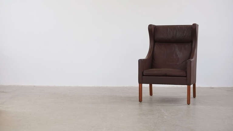 Beautiful highback lounge chair designed by Borge Mogensen for Fredericia, Denmark. Solid teak legs and chocolate brown leather with gorgeous patina