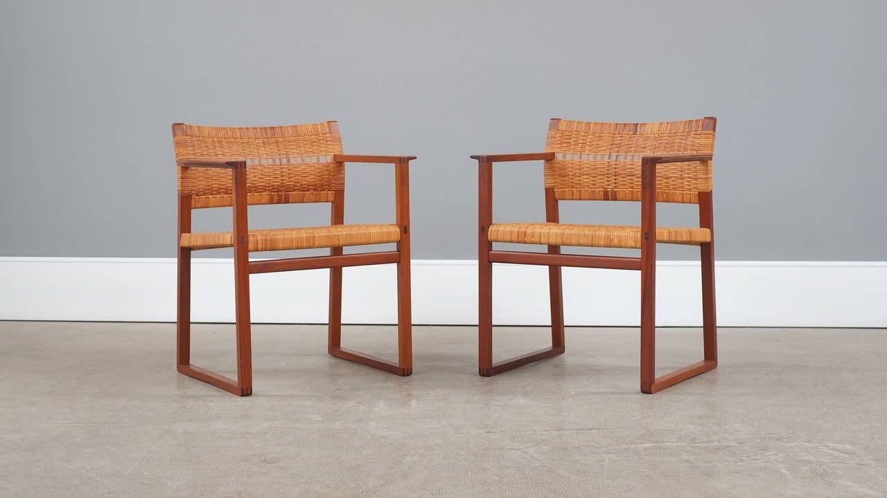 Wonderful pair of armchairs in solid teak with cane seat and back designed by Borge Mogensen in 1957 for P. Lauritsen, Denmark. Extremely elegant design and staggering quality. Seldom seen chairs.