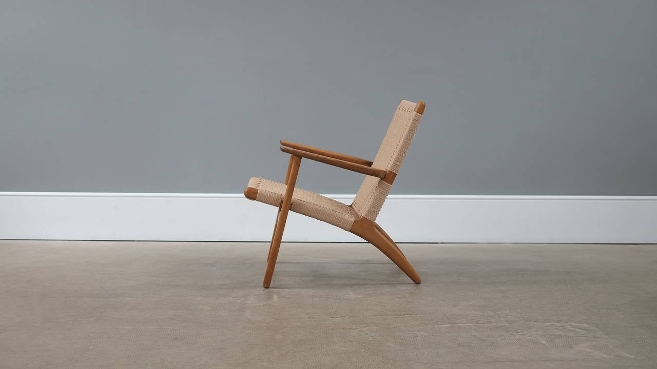 Beautiful CH25 Lounge chair designed by Hans Wegner for Carl Hansen, Denmark. Solid oak frame with new papercord. Very nice early example with superb patina.