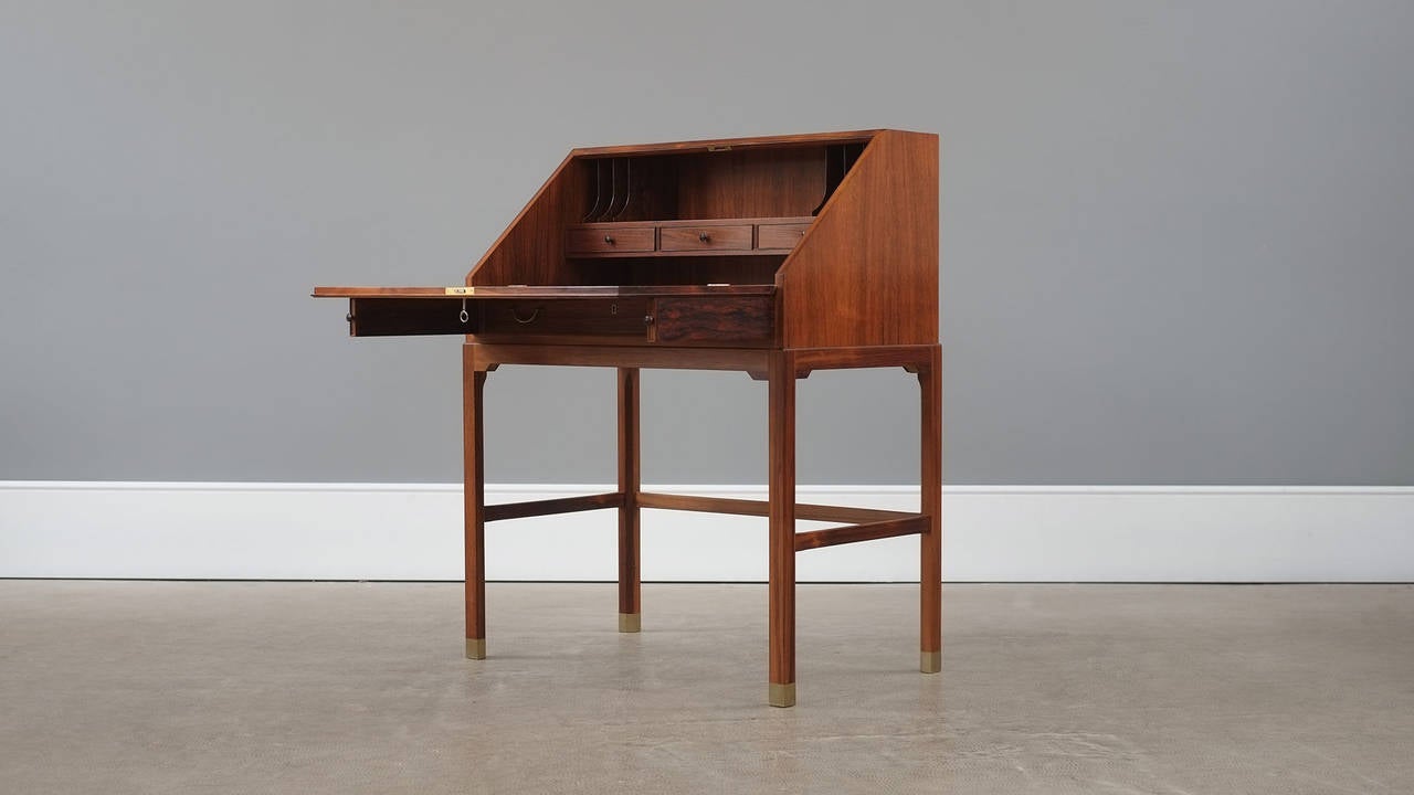 Ultra rare and beautiful secretaire designed by Ole Wanscher and made by master cabinet maker A J Iversen, Denmark. Super elegant and staggering quality piece in amazing rosewood with brass shoes to the legs. Original paper label intact. Wonderful.