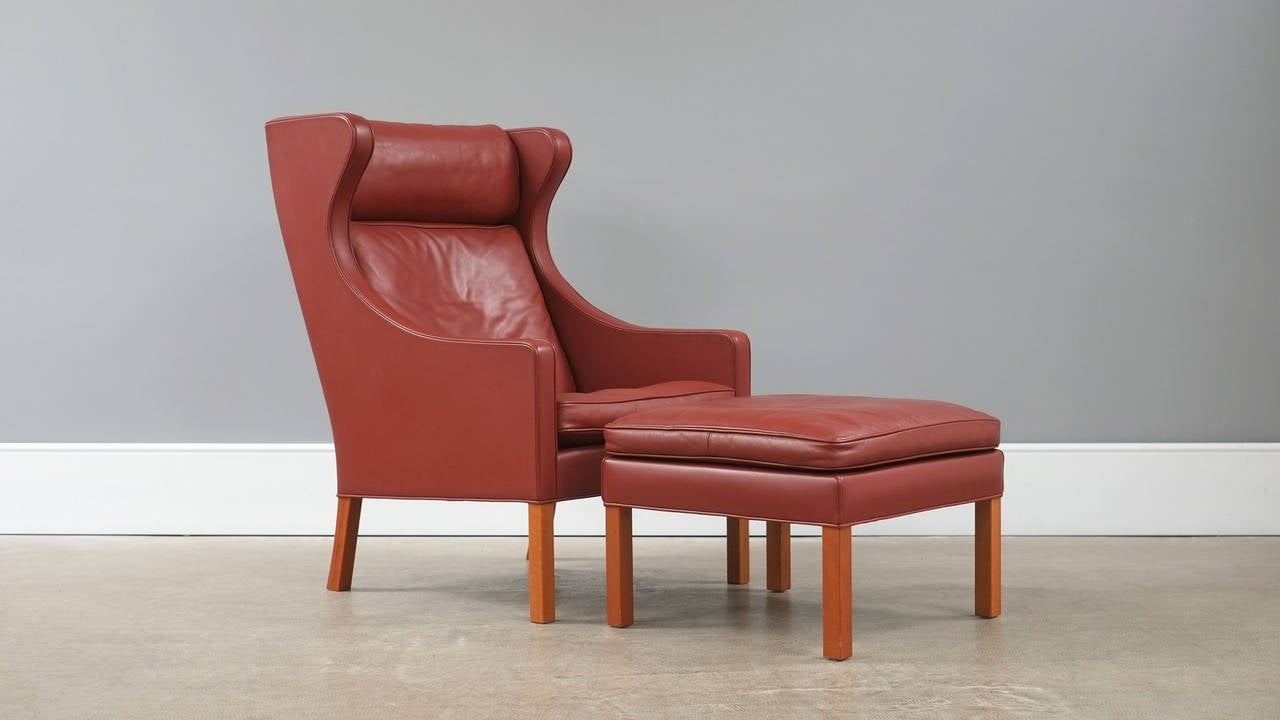 Wonderful club chair and footstool designed by Borge Mogensen for Fredericia, Denmark. This example in beautiful red/brown leather. Super elegant, amazing quality and ultra comfortable. Great piece.