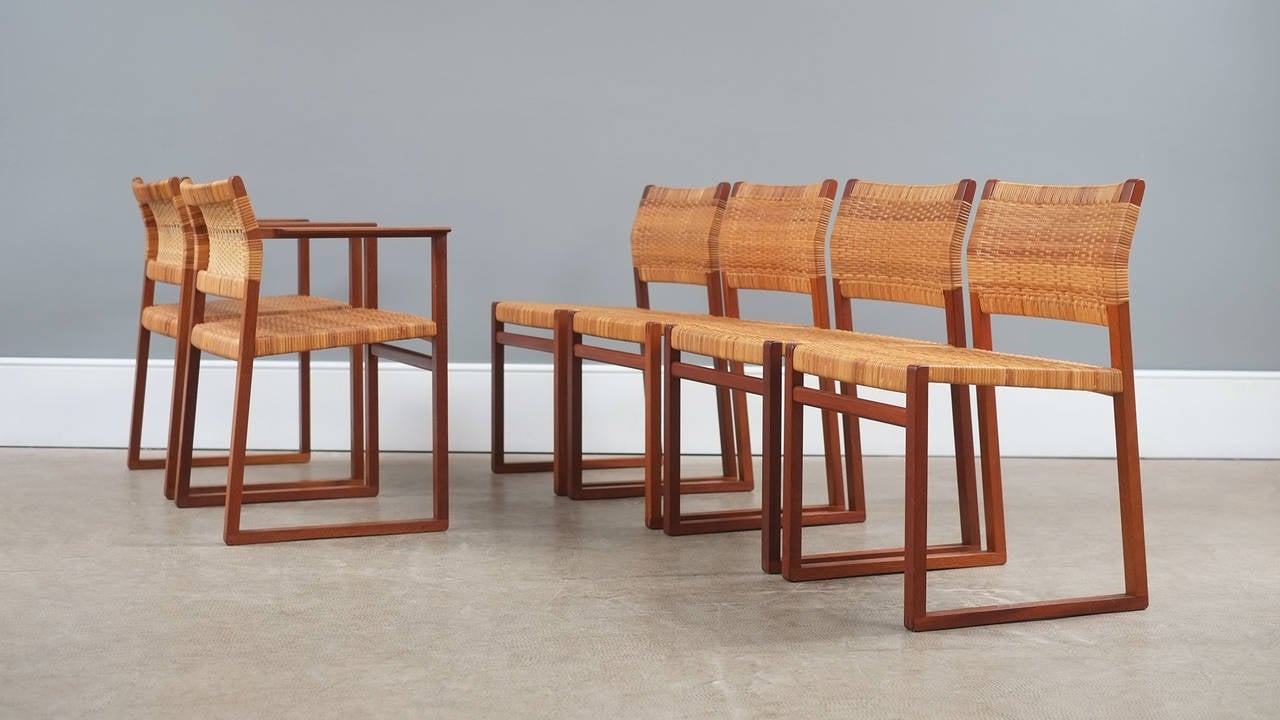 Wonderful set of BM62 dining chairs in solid teak with cane seats and backs designed by Borge Mogensen for P. Lauritzen, Denmark 1957. Set includes 4 side-chairs and two carvers. Ultra elegant chairs with fantastic exposed joint details.
