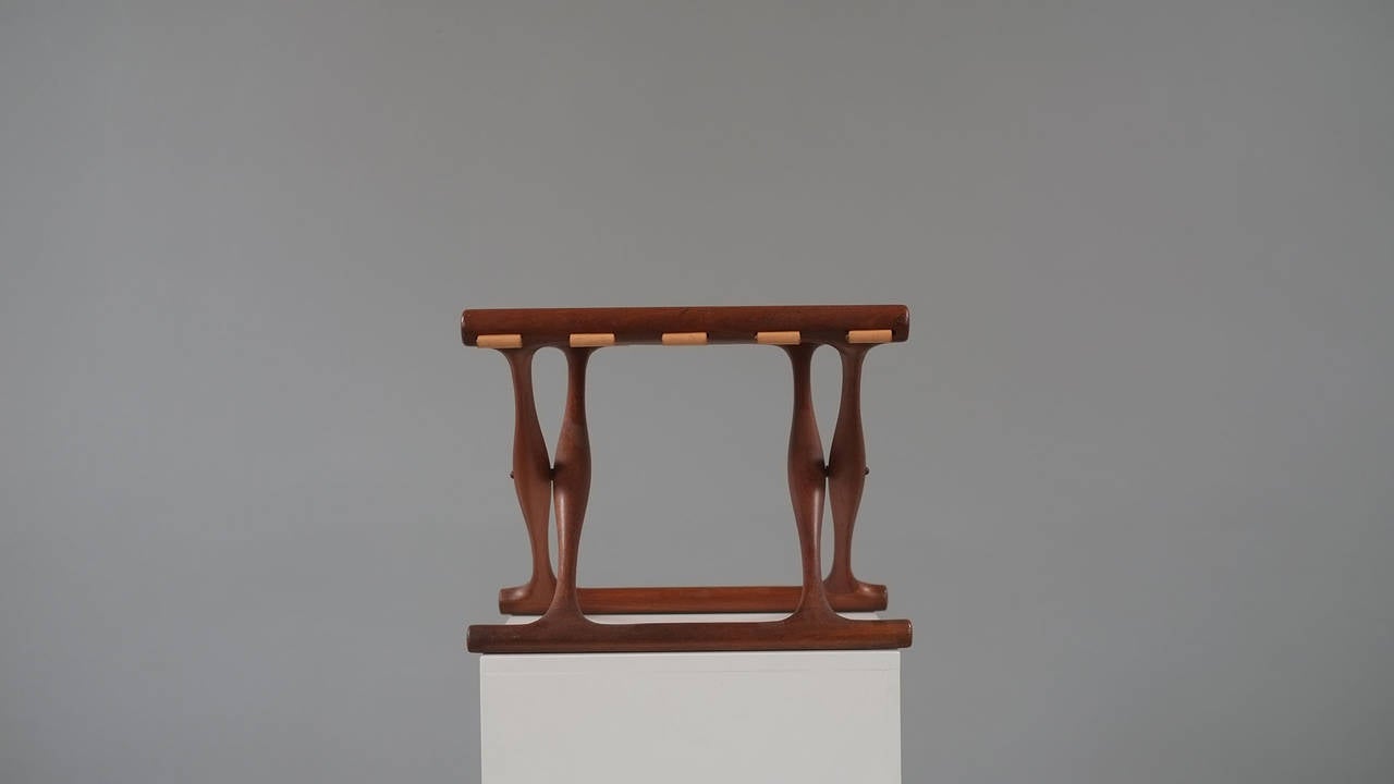 Wonderful Guldhoj, GoldHill, folding stool designed by Poul Hundevad, Denmark. This example in sculptural solid teak with beautifully patinated cognac leather.