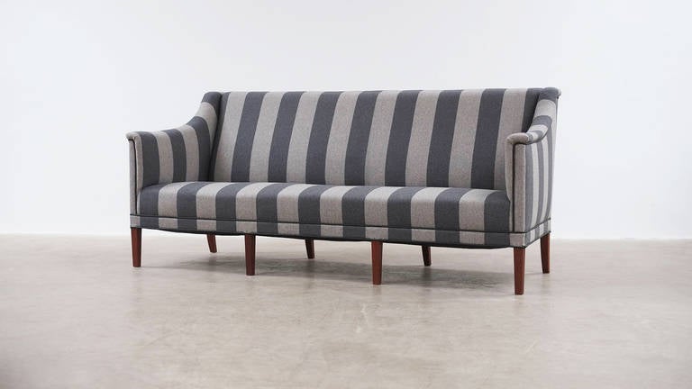 Amazing sofa designed by Kaare Klint for Rud. Rasmussens Snedkerier, Denmark 1941. Ultra elegant and super high quality piece with eight solid teak legs. Fully reconditioned and reupholstered in beautiful striped grey wool with leather piping.