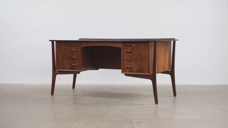 Beautiful desk in rosewood designed by Danish Architect Svend Aage Madsen for H.P. Hansen, Denmark. Very sculptural shape with many wonderful details. Bookcase to the rear. Great piece.