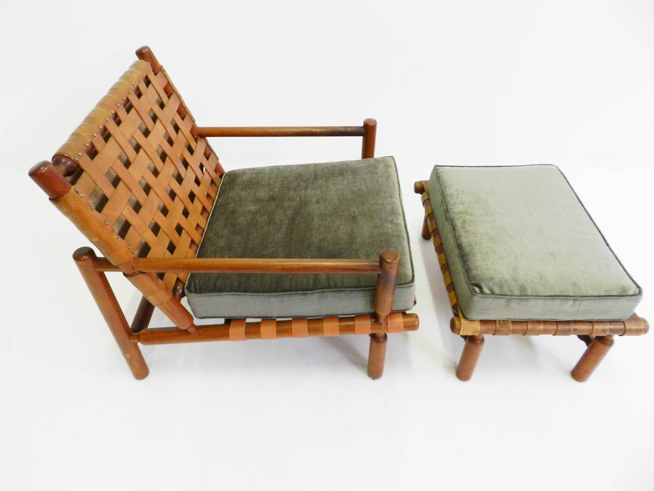 Superb and rare 1957 Ilmari Tapiovaara lounge set finished in beautiful supple sage-green-velvet comprising one lounge chair and ottoman and a three-seat sofa.
The cushions are newly made.
Certain leather stripes have been replaced. Please enquire