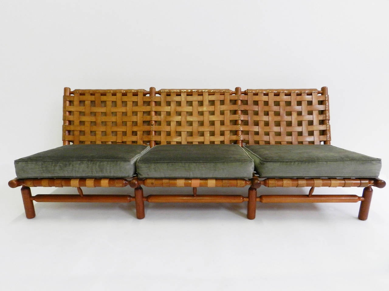 Superb and rare 1957 Ilmari Tapiovaara lounge set finished in beautiful supple sage-green-velvet comprising one lounge chair and ottoman and a three-seat sofa.
The cushions are newly made.
Certain leather stripes have been replaced. Please enquire