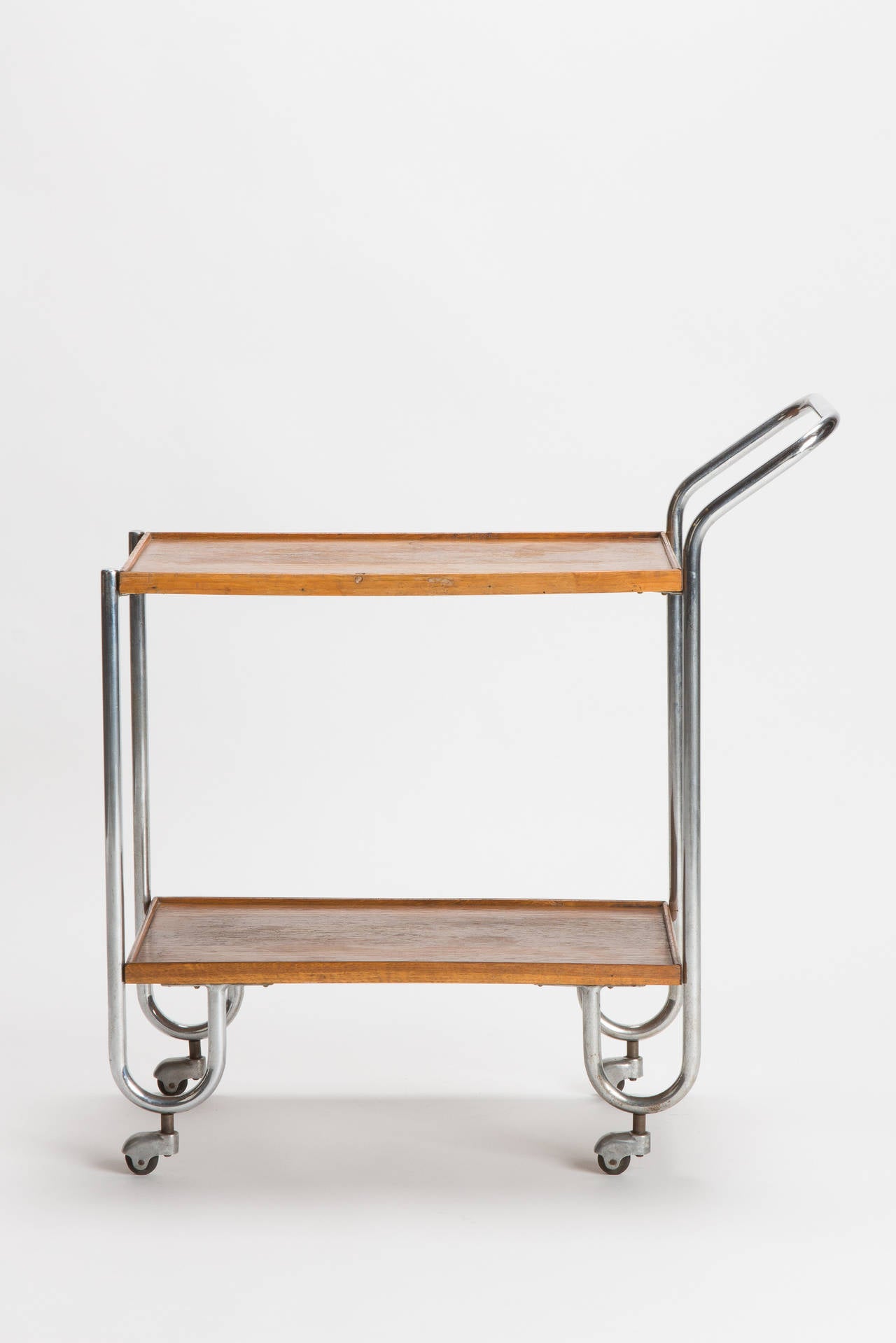 Stunning and unique Bauhaus bar cart from the 1930s, Italy. The shelve spaces are made of oak, steel tube frame on adorable old wheels.