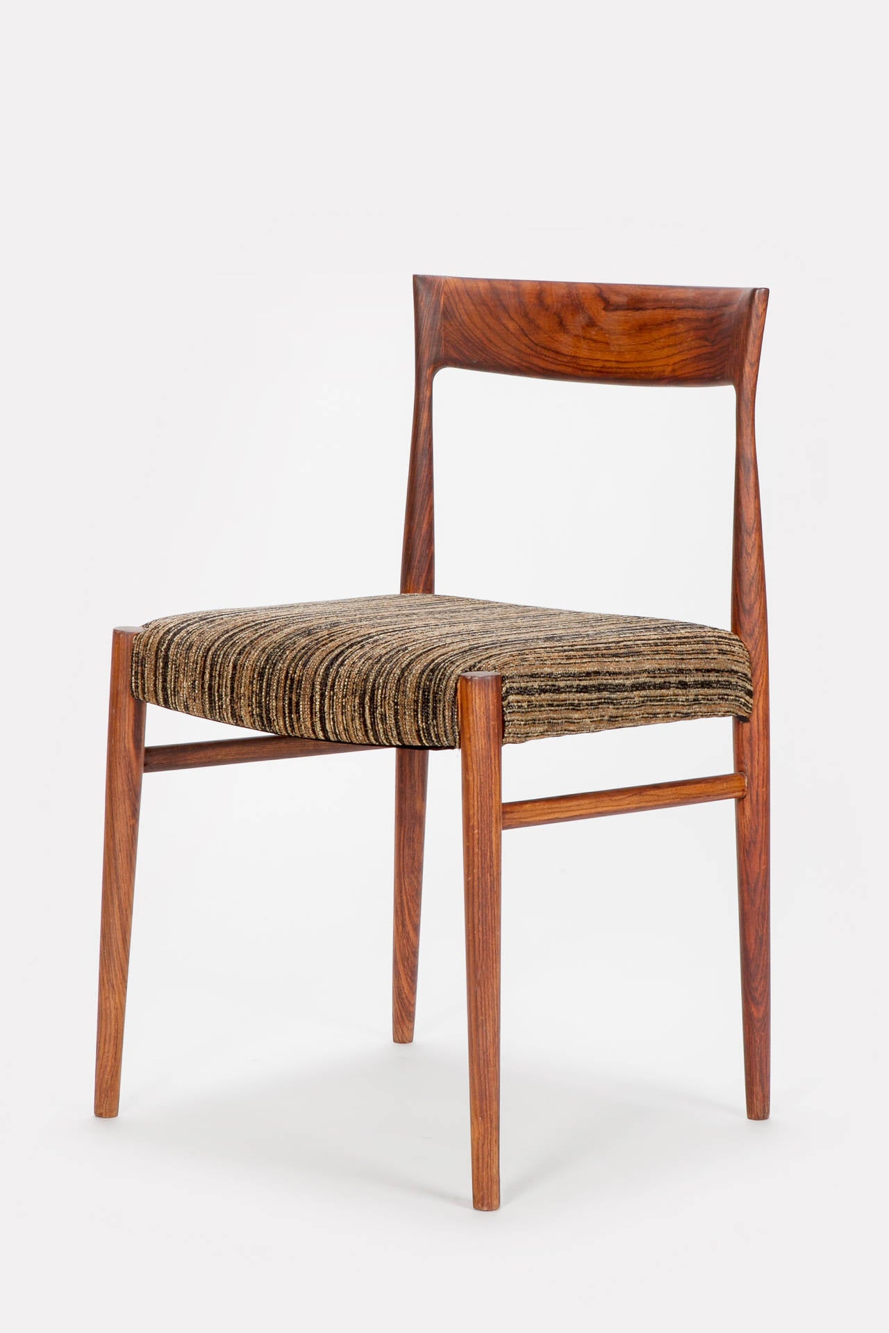 Set of 4 danish Rosewood Chairs from the 1960's. The chairs were distributed by Casala. Beautiful grain in wood, refurbished and reupholstered in a fine cotton fabric!