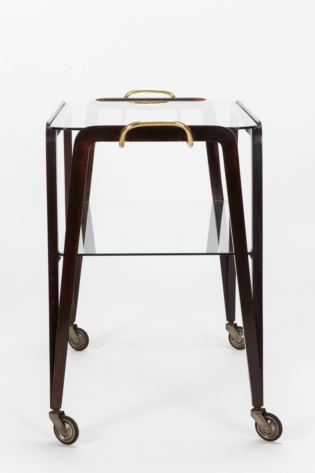 Most stunning bar cart attributed to Ico Parisi, Italy, 1950s. The frame is made of lacquered mahogany, beautiful brass details and glass shelves. Very elegant and sophisticated shape!