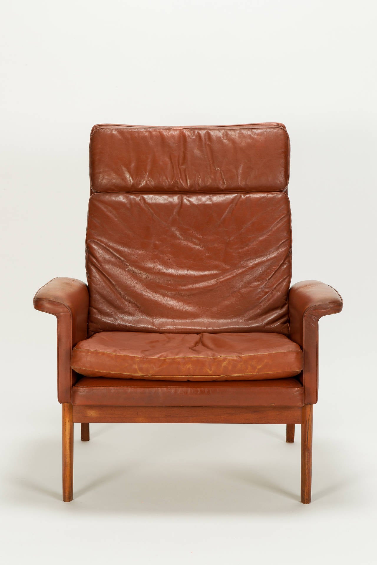 Rare Finn Juhl Jupiter chair, model No 218 for France & Son, designed in 1965, manufactured in Denmark in the mid 1960s. Spring-suspended backrest allows to rock a bit. Original rust colored leather with a nice vintage patina