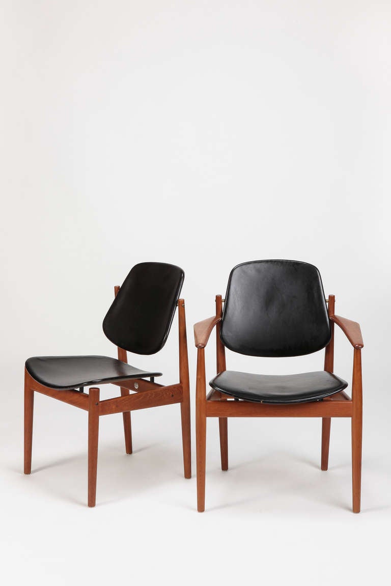 A set of eight special dining chairs by Arne Vodder designed for France & Søn, Denmark. One chair with armrests. Made of solid teak with leather covered seats and backrests. The backrests are adjustable