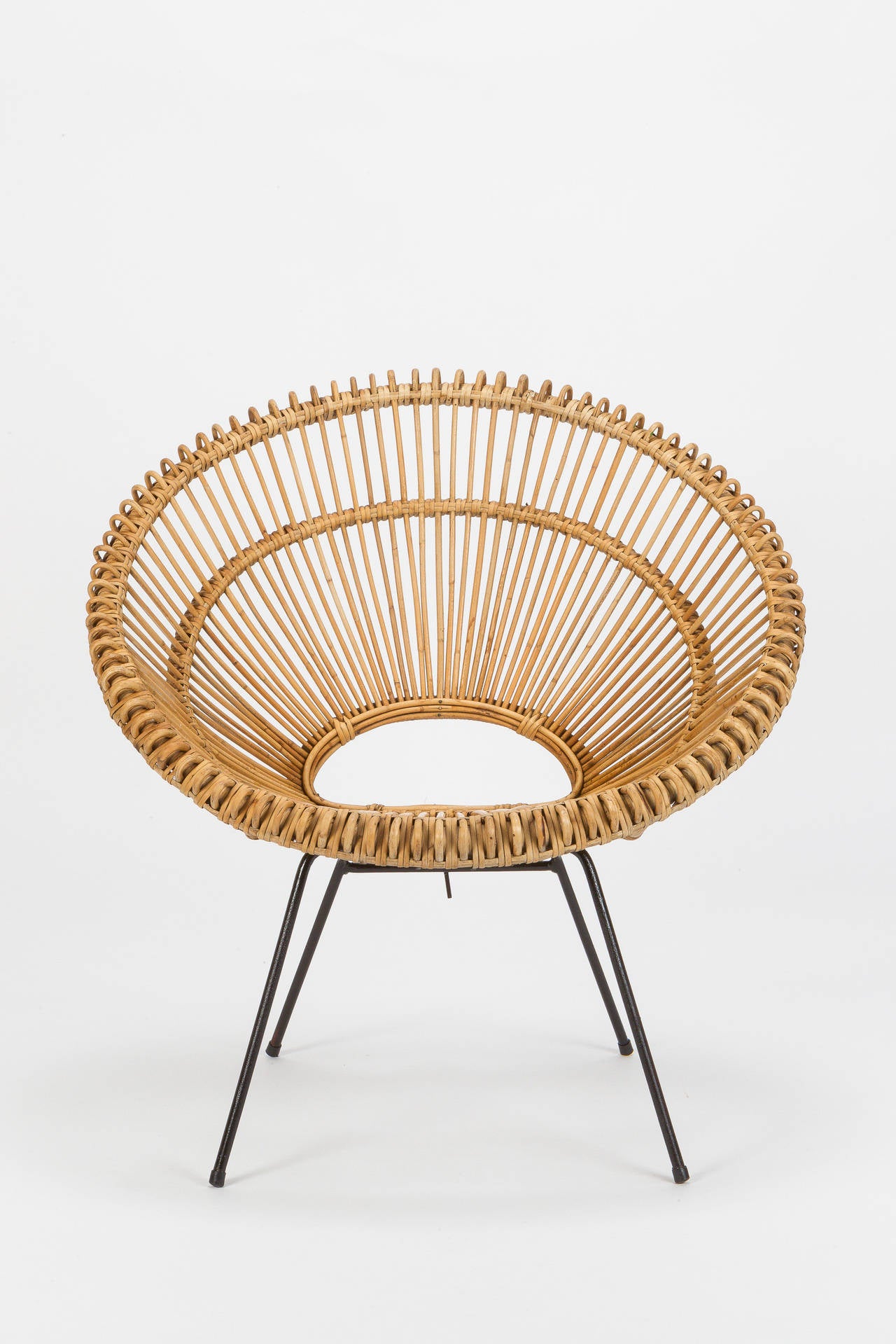 Beautiful wicker chair attributed to Janine Abraham & Dirk Jan Rol. Very nicely shaped and crafted of woven bamboo, the base is made of lacquered metal and can be removed for shipping