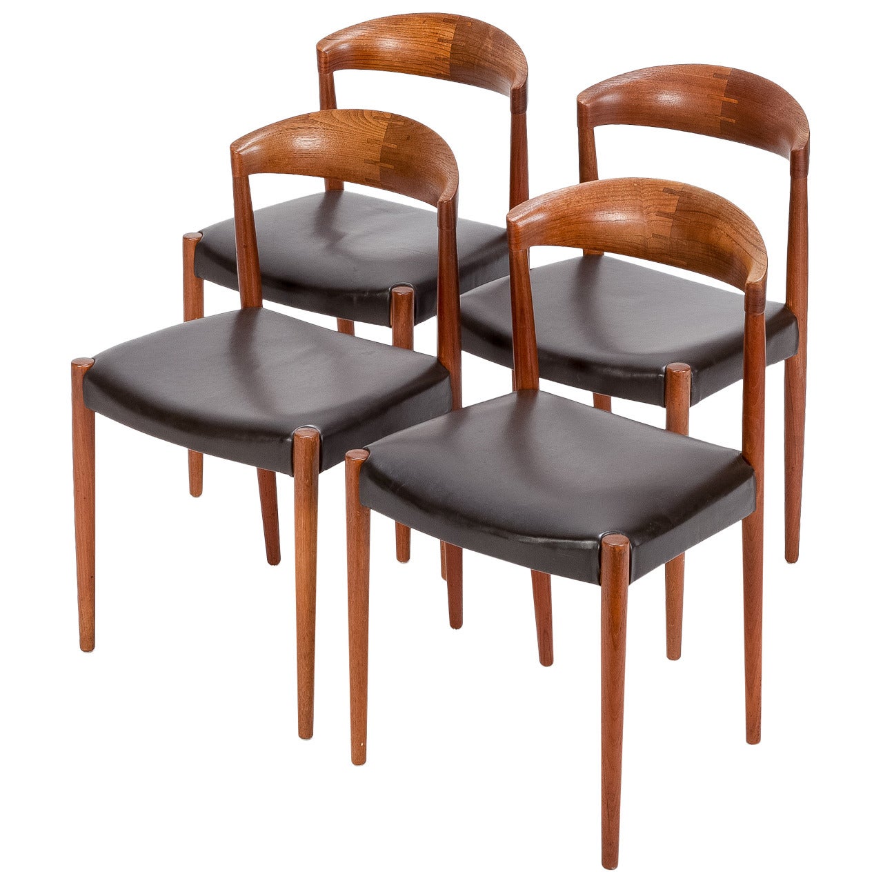 Set of four Danish chairs in teak and leather by Knud Andersen, manufactured in the 1960s. Round shaped backrest with beautiful details, solid constructed with a fine leather cover. In very good condition with a nice and warm patina!
