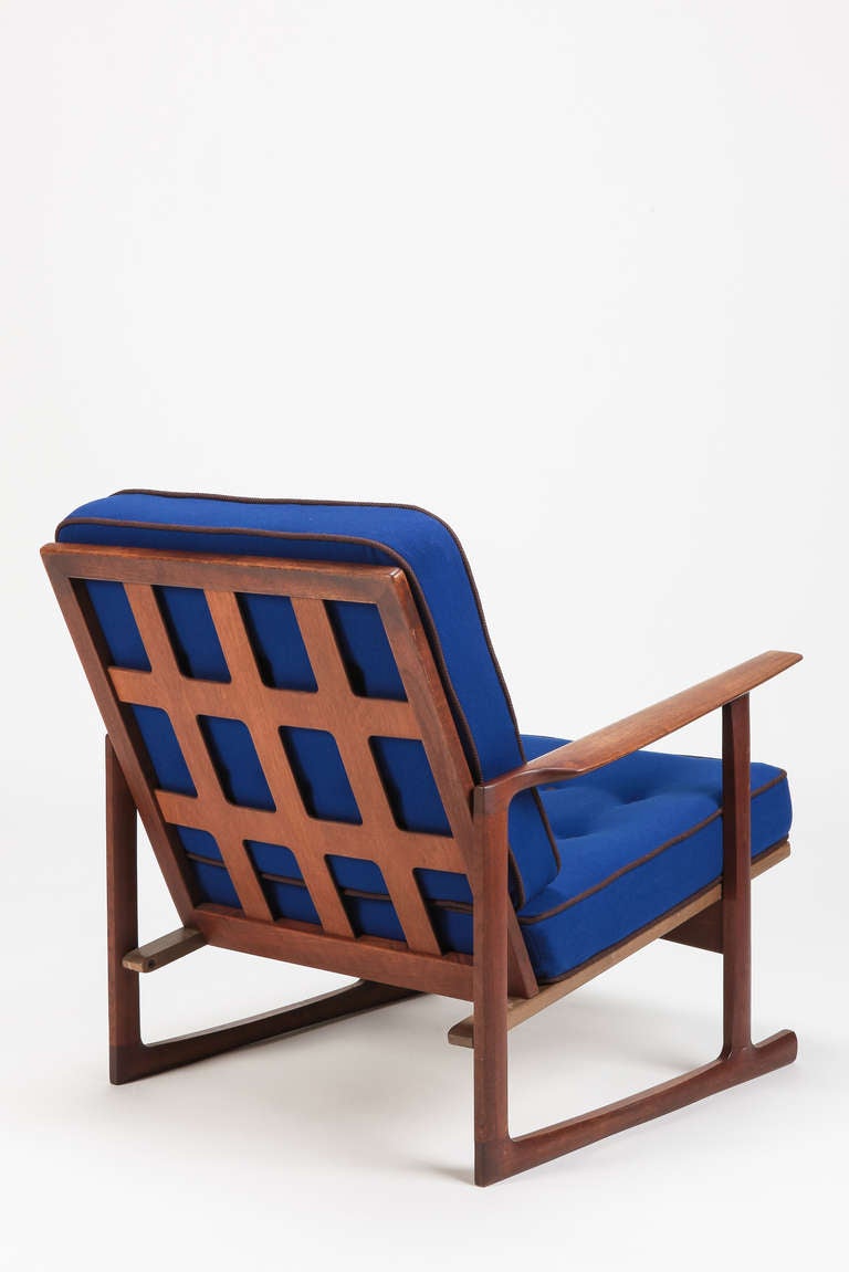 Single Easy Chair in solid teakwood by Ib Kofod-Larsen, made in Denmark by Selig, 1960's. Recently new upholstered and covered with a fine royal blue wool fabric featuring brown buttons and seam. The lattice back and skids make this chair very