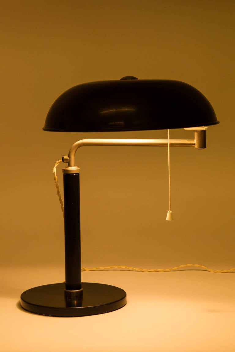 Classical Bauhaus Desk Lamp by Alfred Mueller for AMBA, Switzerland 1930s. The black lacquered lampshade can be brought in various positions all around. Please notice that the fabric wires are in black, not like on the photos.