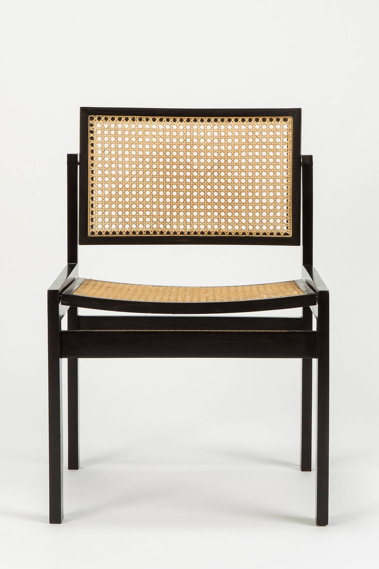 Pair of classical Swiss design chairs by Kurt Thut, designed in 1955 as the diploma thesis at the art school of Zurich, manufactured by Thut Mo¨bel in Switzerland in the late 1950s. Lacquered beech-wood frame and hole to hole caning seat and